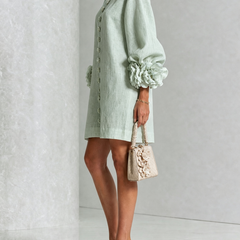 Sage green button-down mini dress, side view, with vertical buttons and puff sleeves