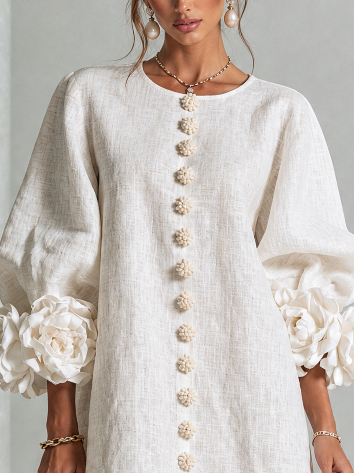 White button-down mini dress with vertical gold button placket and round neckline