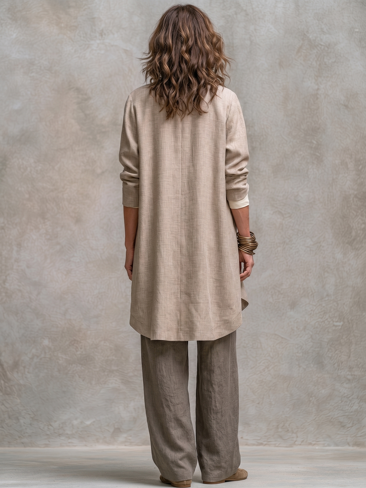 Taupe three-piece suit set, back view: long blazer and wide-leg trousers