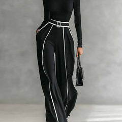 Black high-neck long-sleeve top and wide-leg pants set with white trim and waist belt buckle.