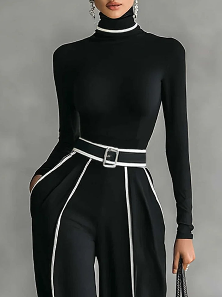 Black high-neck long-sleeve top with white-trim paneling and waist belt buckle.