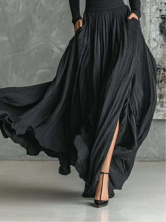 Black pleated midi skirt with draped fabric and side slit