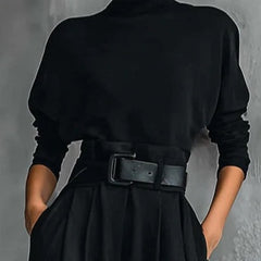 Black turtleneck long-sleeve top with wide cuffs and a belted high waist