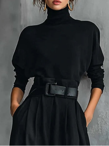 Black turtleneck long-sleeve top with wide cuffs and a belted high waist