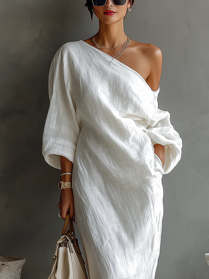 White one-shoulder maxi dress with wrap drape and three-quarter sleeves