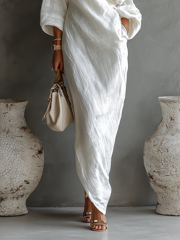 White one-shoulder wrap maxi dress with draped sash and gathered fabric