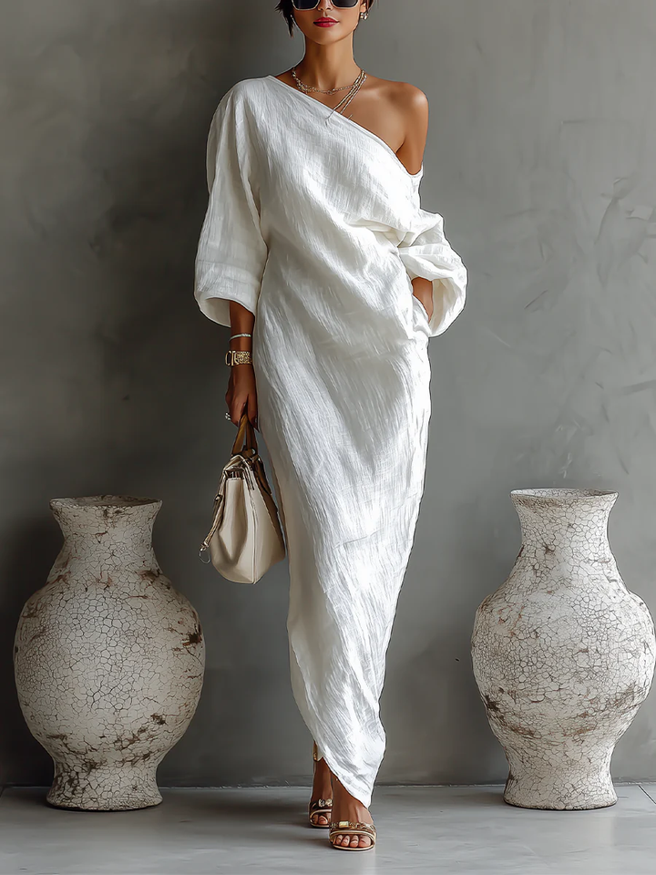 White one-shoulder maxi dress with draped sash and three-quarter sleeves