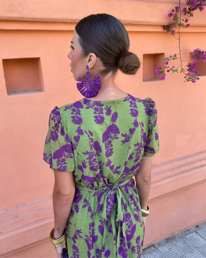 Back view: green and purple floral wrap midi dress with tied waist and puff sleeves