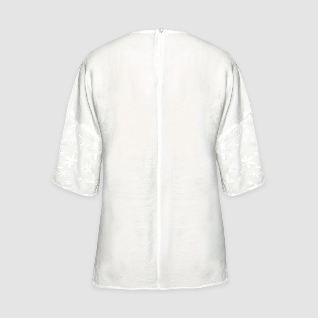 White loose-fit tunic shirt back with center seam and small button detail at neckline