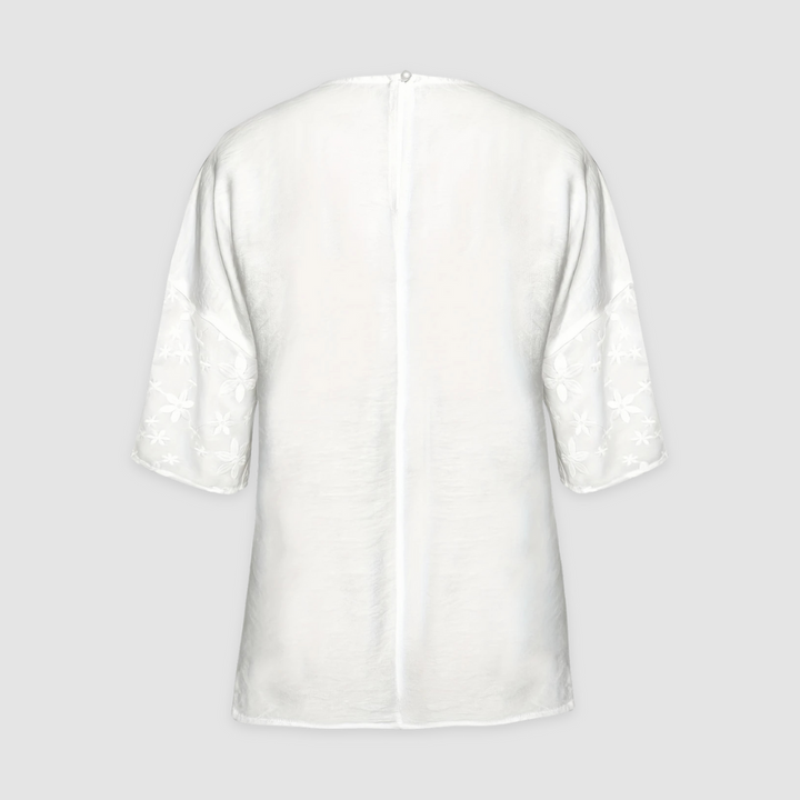 White loose-fit tunic shirt back with center seam and small button detail at neckline