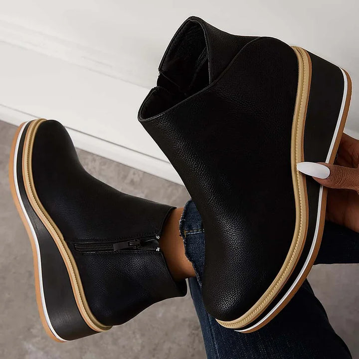 Black lace-up ankle boots with side zipper and tan-striped soles