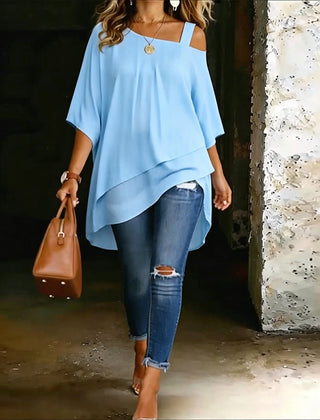 Light blue asymmetric blouse with wide square neckline and draped hi-lo hem