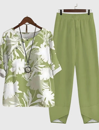 Two-piece set: green short-sleeve top and matching pants, white botanical leaf print
