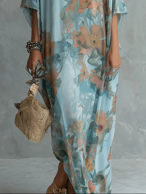 Light blue floral maxi dress with flowing hem and short flutter sleeves