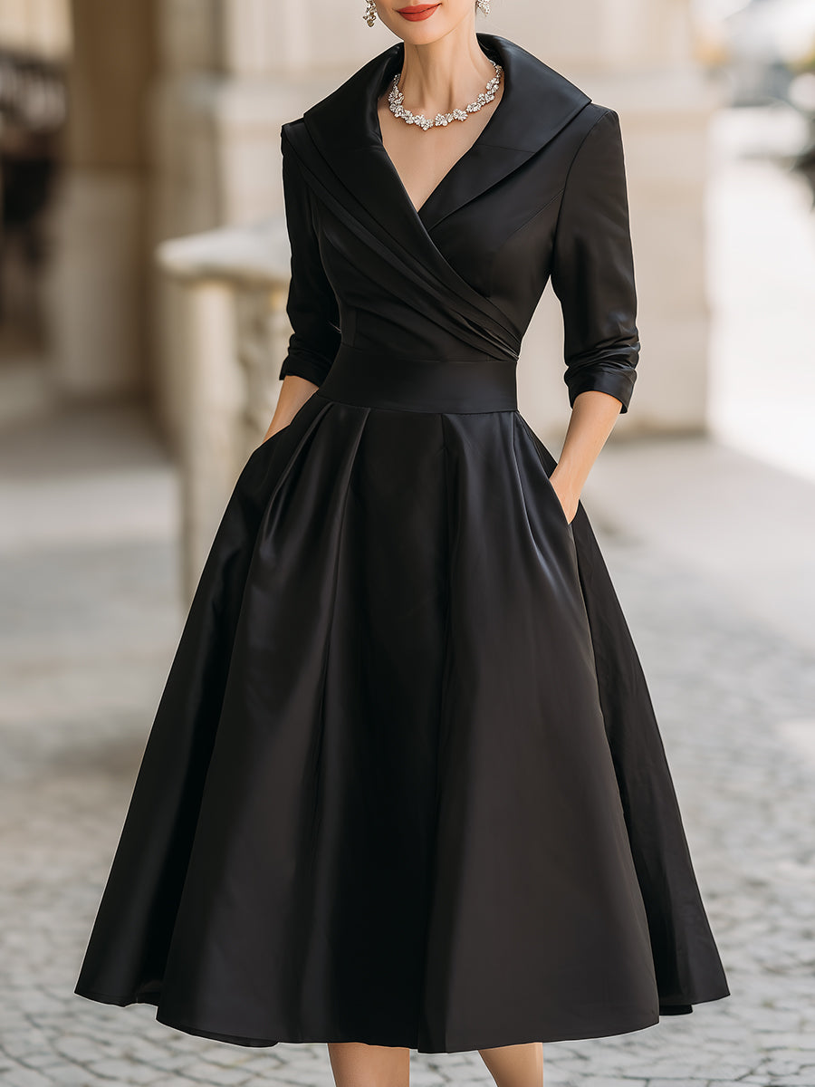 Black midi dress with wrap neckline, 3/4 sleeves, and flared pleated skirt