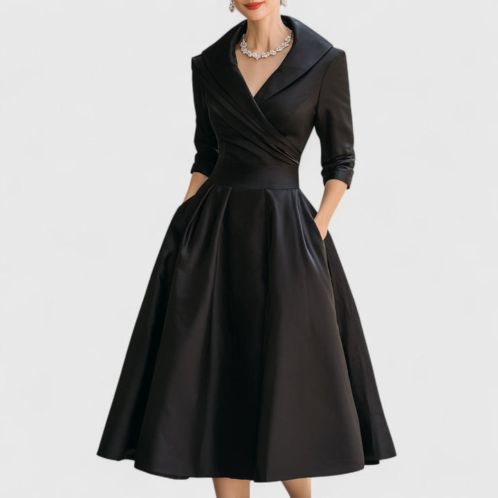 Black midi wrap dress with V-neck, 3/4 sleeves, pleated full skirt.