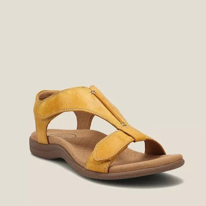 Yellow orthopedic vegan leather sandal with open toe, wide strap, and cushioned sole.