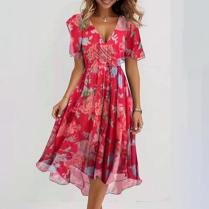 Red floral summer dress with V-neck, short sleeves, and flowing tiered skirt