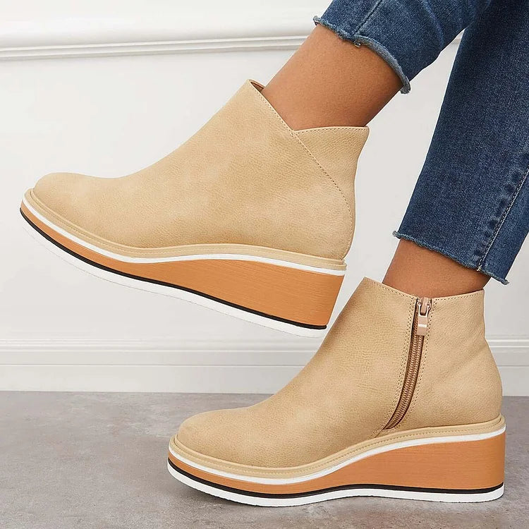 Beige ankle boots with side zipper and tan platform wedge sole with white edge