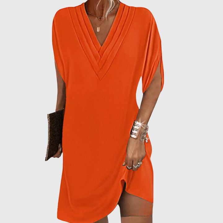 Orange draped V-neck dress with short sleeves and wrap-like crossover front