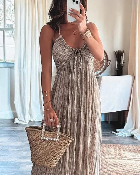 Beige sleeveless maxi dress with thin straps, V neckline, and draped bodice