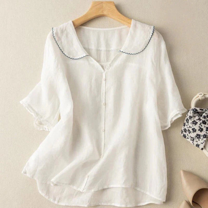 White cotton short-sleeve blouse with scalloped peter pan collar and button front