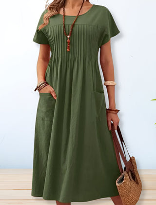 Green midi day dress, round neck, short sleeves, gathered front, patch pockets.