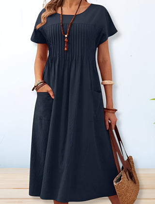 Blue midi A-line dress with round neck, short sleeves, gathered yoke, side patch pockets.