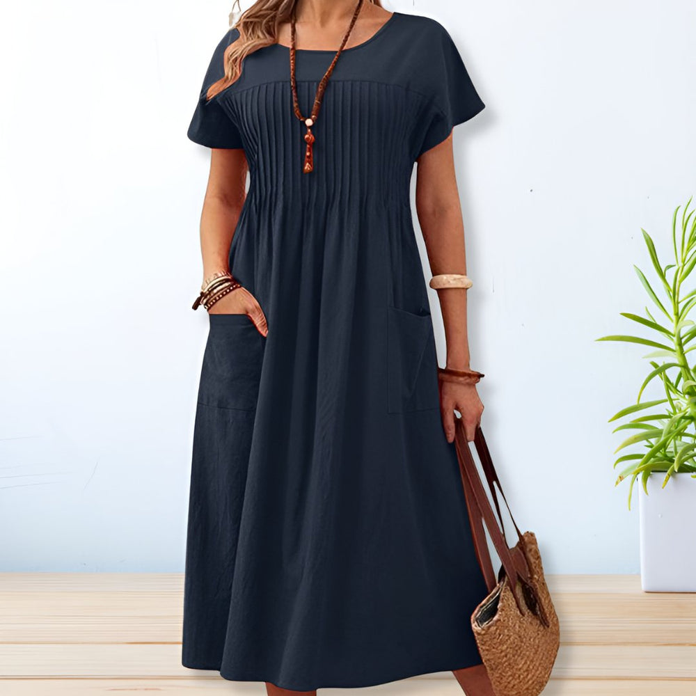 Blue midi A-line dress with round neck, short sleeves, gathered yoke, side patch pockets.