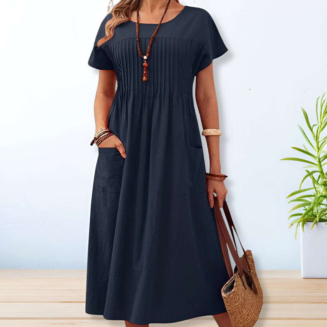 Blue midi A-line dress with round neck, short sleeves, gathered yoke, side patch pockets.