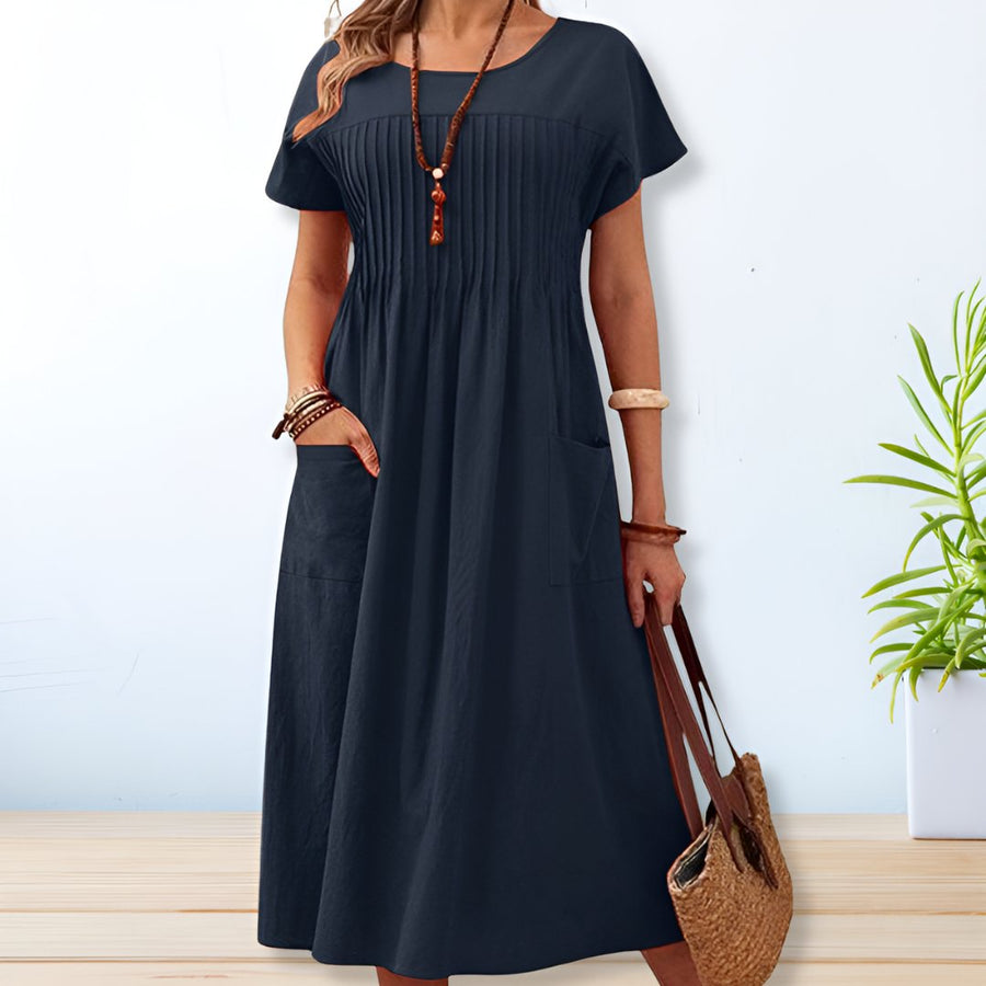 Blue midi A-line dress with round neck, short sleeves, gathered yoke, side patch pockets.