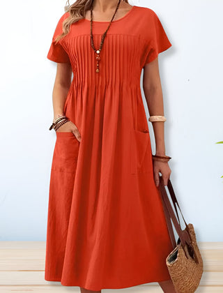 Orange midi day dress, round neck, short sleeves, gathered front, patch pockets.