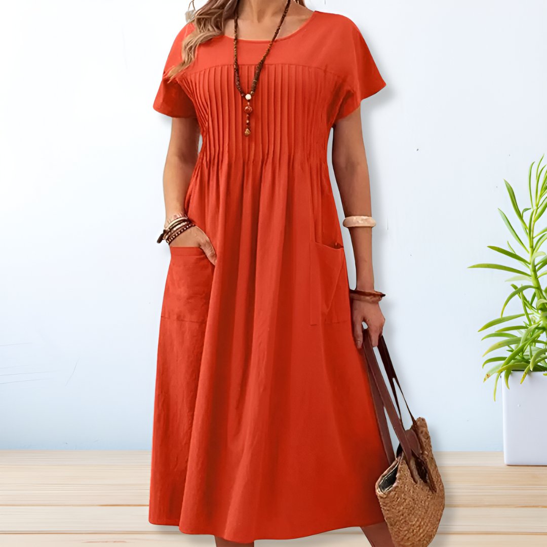 Orange midi day dress, round neck, short sleeves, gathered front, patch pockets.