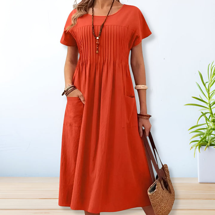 Orange midi day dress, round neck, short sleeves, gathered front, patch pockets.