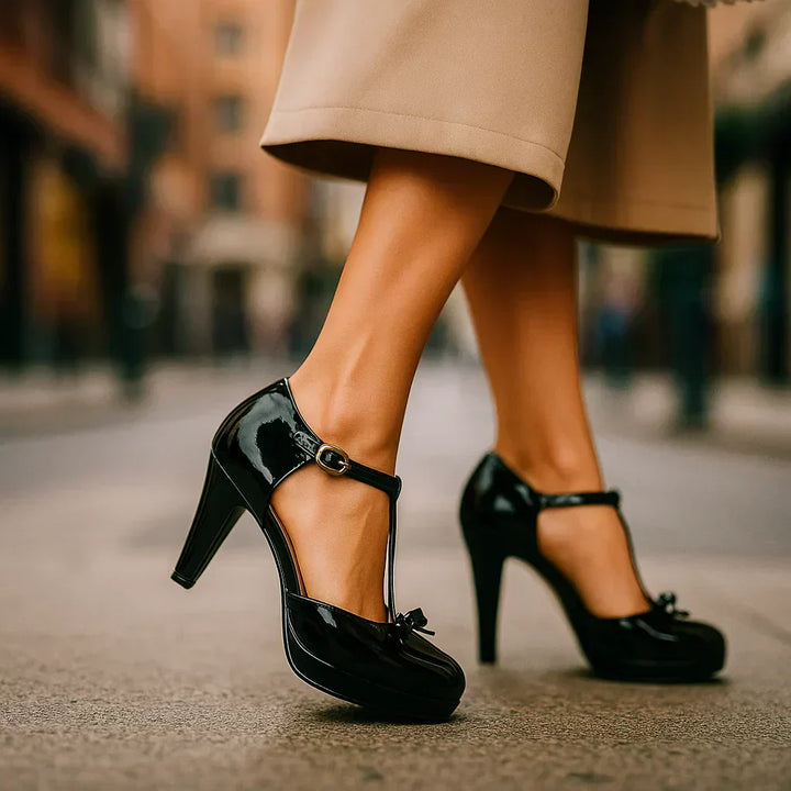 Estelle tie-strap pumps in classic black patent with ankle strap and bow at vamp