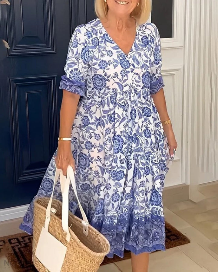 Blue floral V-neck dress with short sleeves and gathered tiered skirt