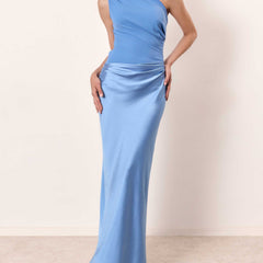 One-shoulder pleated satin maxi dress in light blue with draped waist and floor-length skirt.