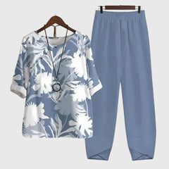 Two-piece set: light blue short-sleeve top and matching pants, white floral foliage print