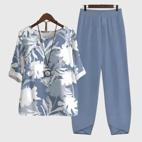 Two-piece set: light blue short-sleeve top and matching pants, white floral foliage print