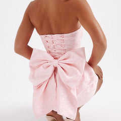 Pink strapless jacquard mini dress rear view with waist bow-knot detail