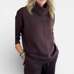 Burgundy two-piece lounge set close-up: hooded pullover and matching pants