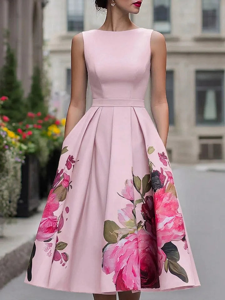 Blush pink sleeveless midi dress with fitted bodice and full skirt, large pink floral print