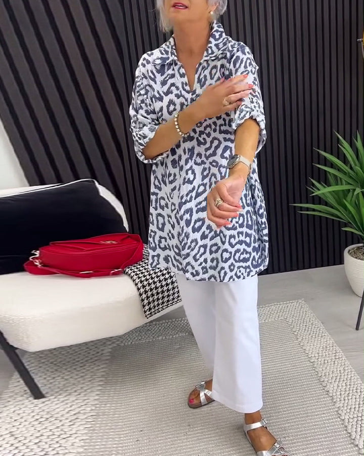 Black-and-white leopard-print collar blouse with 3/4 sleeves and split neckline, tunic length.