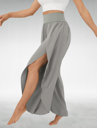 Gray wide-leg pants with elastic waist and flowing side slit drape