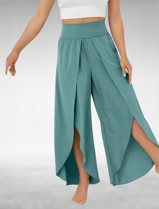 Turquoise wide-leg pants with elastic waist and draped side slit hem