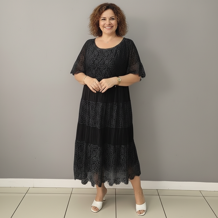 Black lace dress with tiered ruffle panels, short sleeves, and scalloped hem