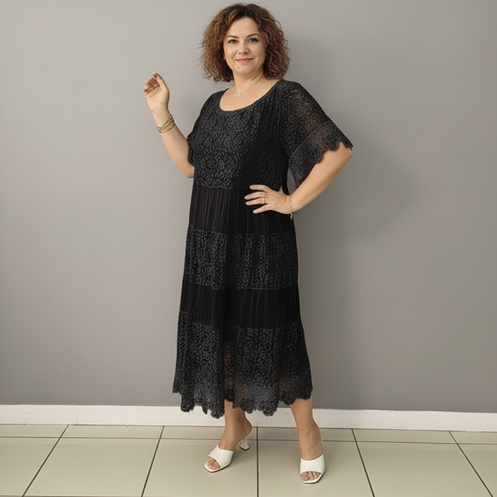 Black tiered lace midi dress with short flutter sleeves and scalloped edges