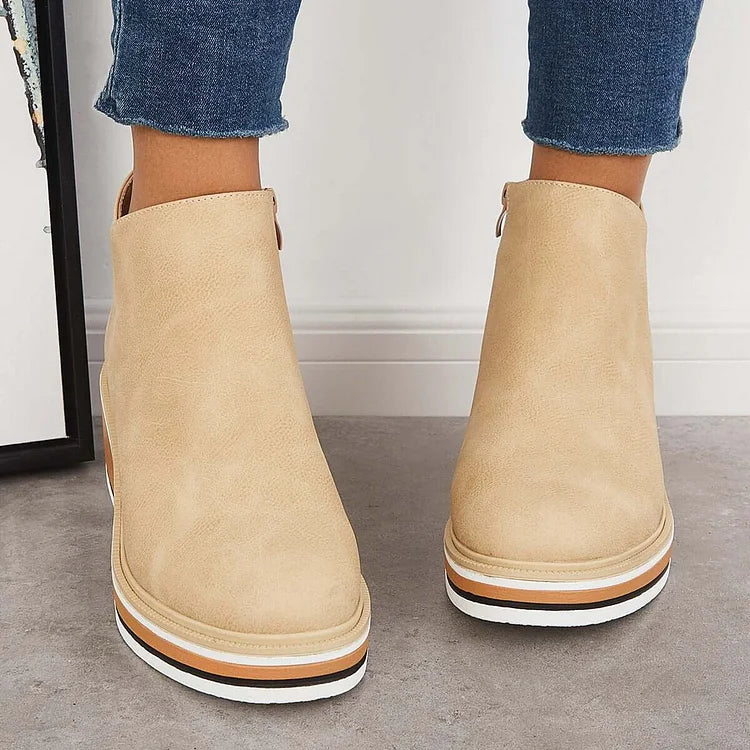 Beige ankle boots with side zipper and tan platform wedge, white sole trim