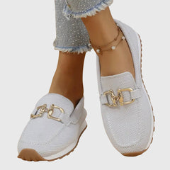 White loafer sneakers with gold-tone buckle detail and cushioned insole