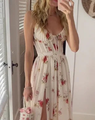 White floral maxi dress with spaghetti straps, V-neck bodice, and tiered skirt
